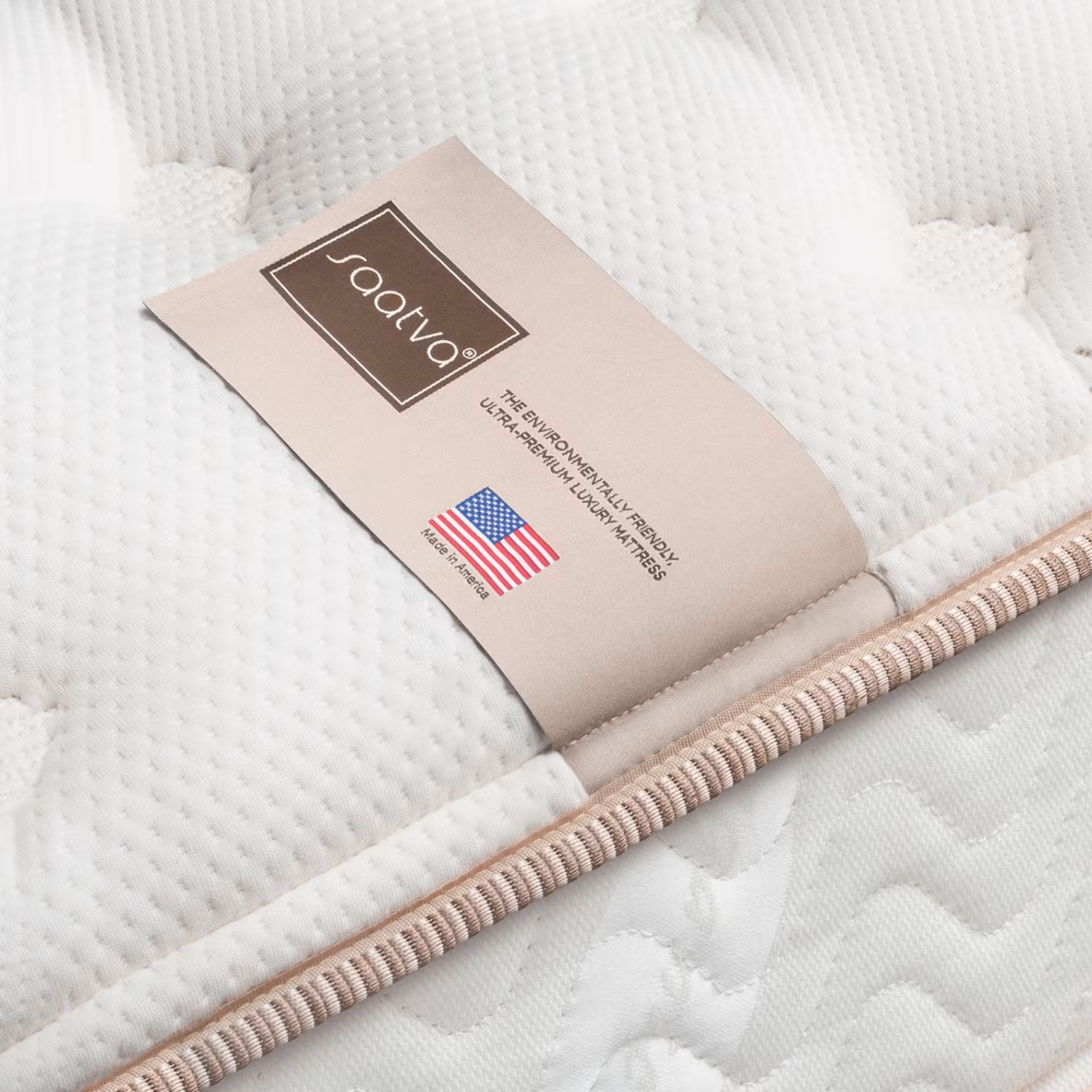 Close-up of Saatva luxury mattress label and quilted cover